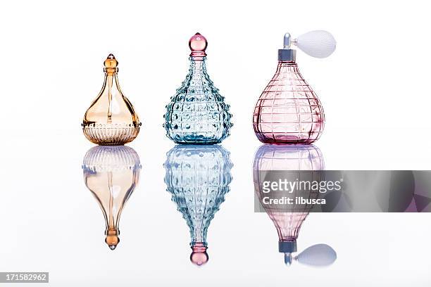 perfume bottles studio shot on white with reflection - perfume stockfoto's en -beelden