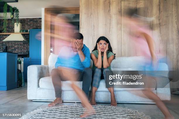 parents tired of noisy children who are running and shouting - adhd stockfoto's en -beelden