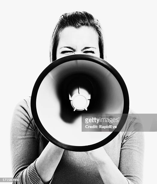 woman obscured by megaphone she holds - public address system stock pictures, royalty-free photos & images