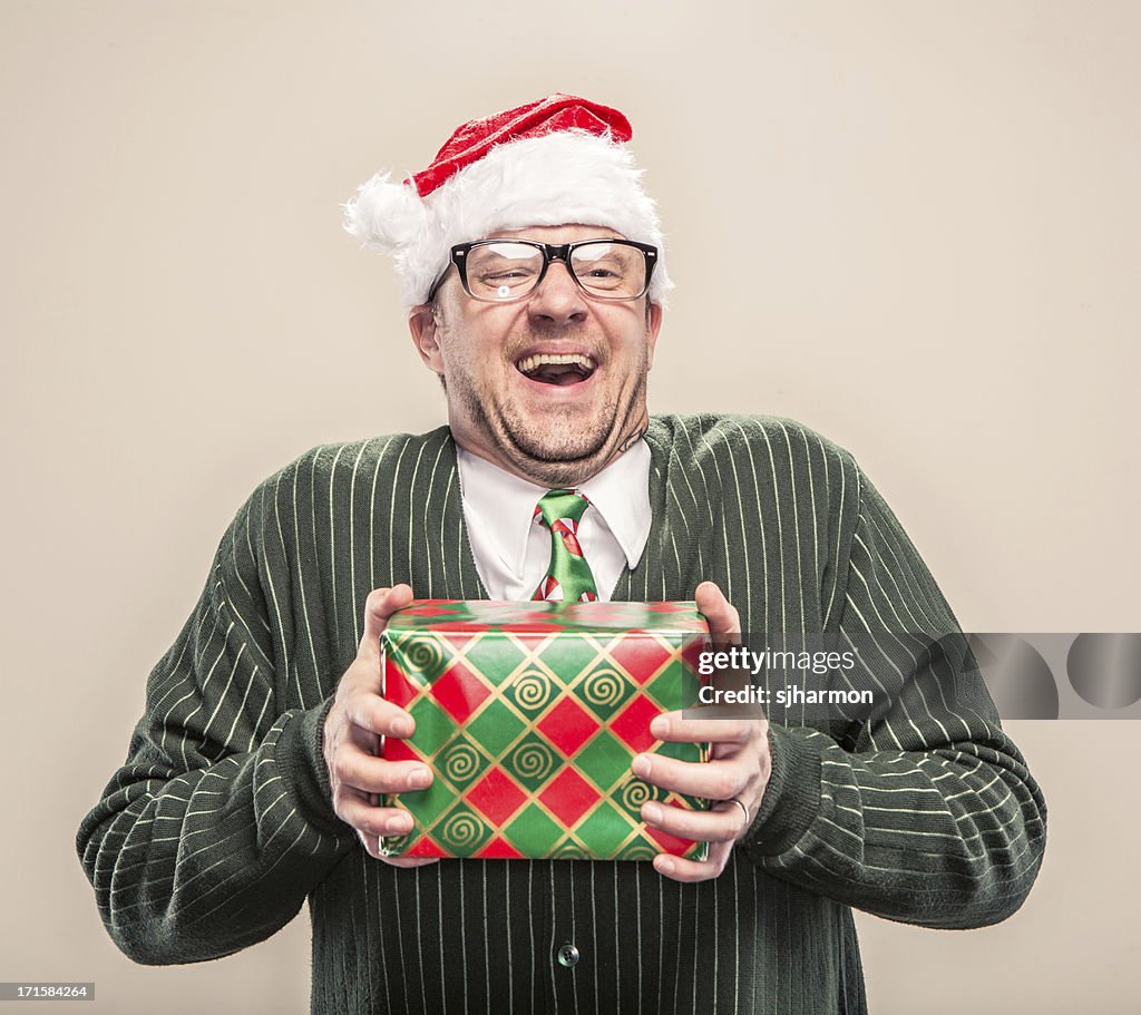 Nerdy Geek Christmas Man holding wrapped holiday gift