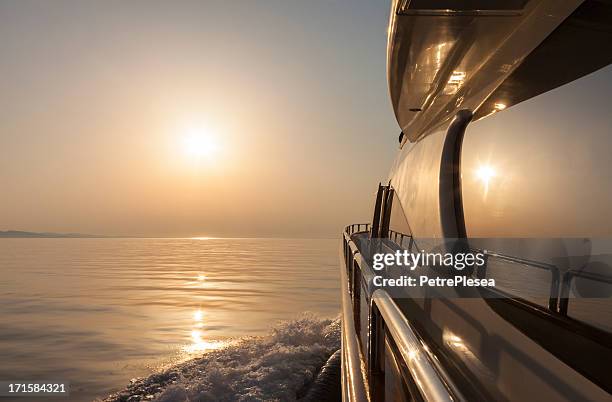 luxury motor yacht sailing at sunset - motorjacht stockfoto's en -beelden