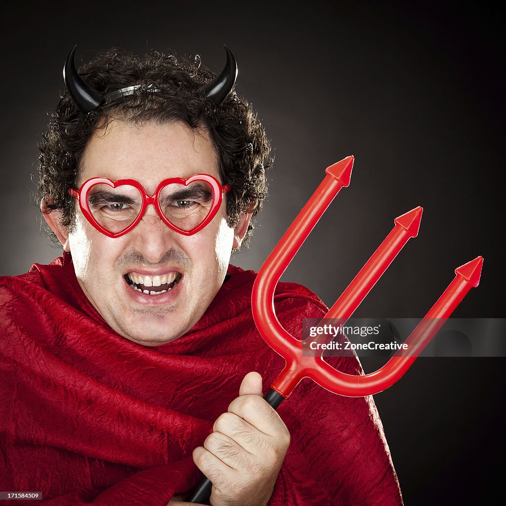 Fool devil with trident on black background