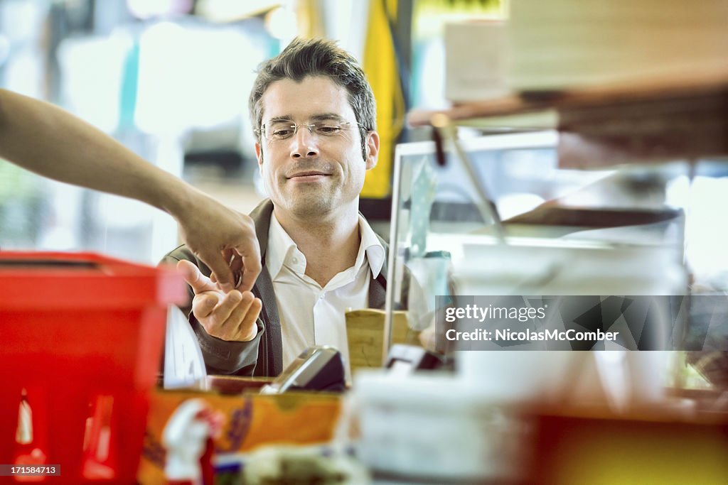 Satisfied man receives change at street vendor