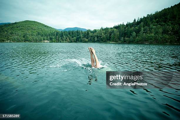 jumping into water - diving into water stock pictures, royalty-free photos & images