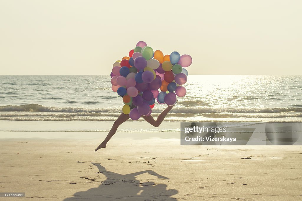 Jumping girl with balloons