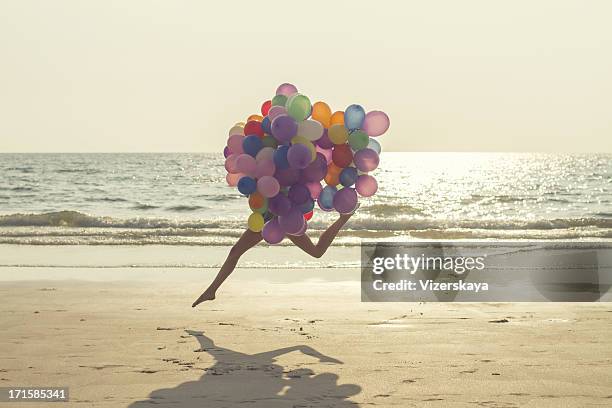 jumping girl with balloons - lightweight stock pictures, royalty-free photos & images