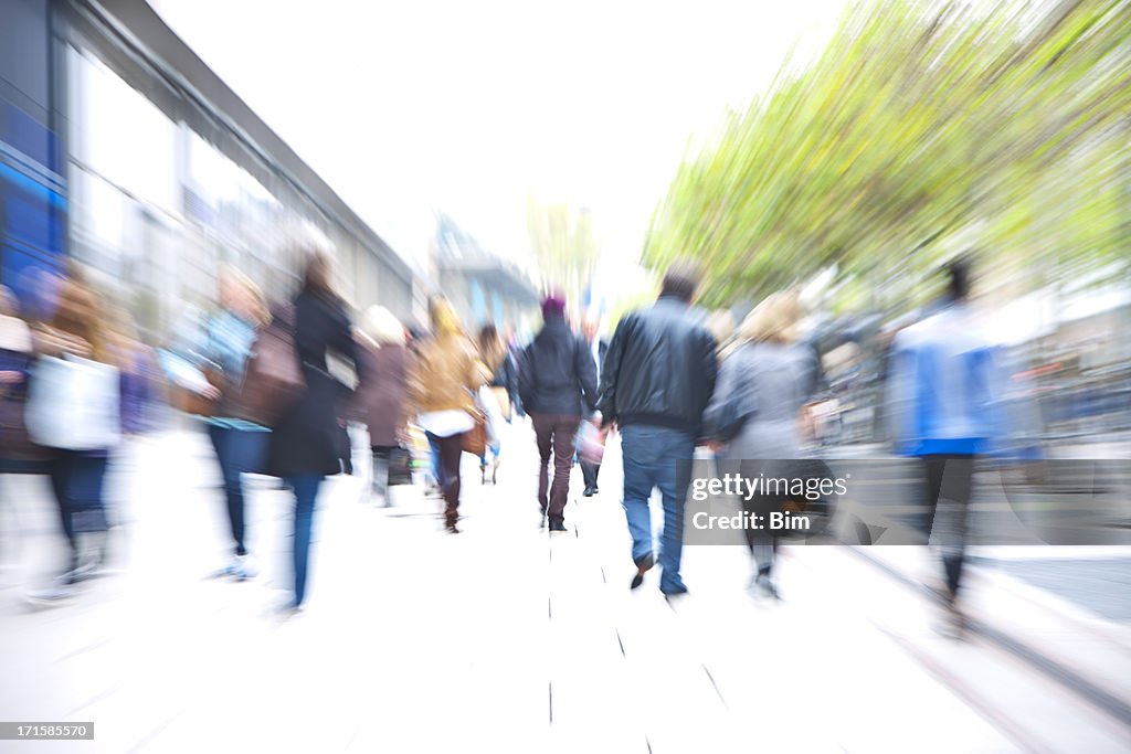 Crowd of People Walking Down Walkway Past Stores, Blurred Motion