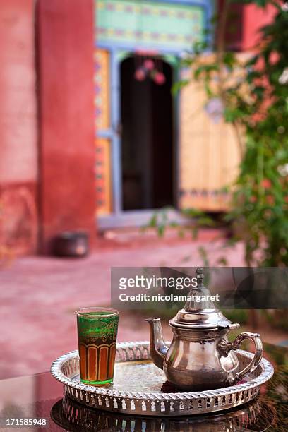 pfefferminztee serviert in marokkanischen riad (innenhof) - atrium grundstück stock-fotos und bilder