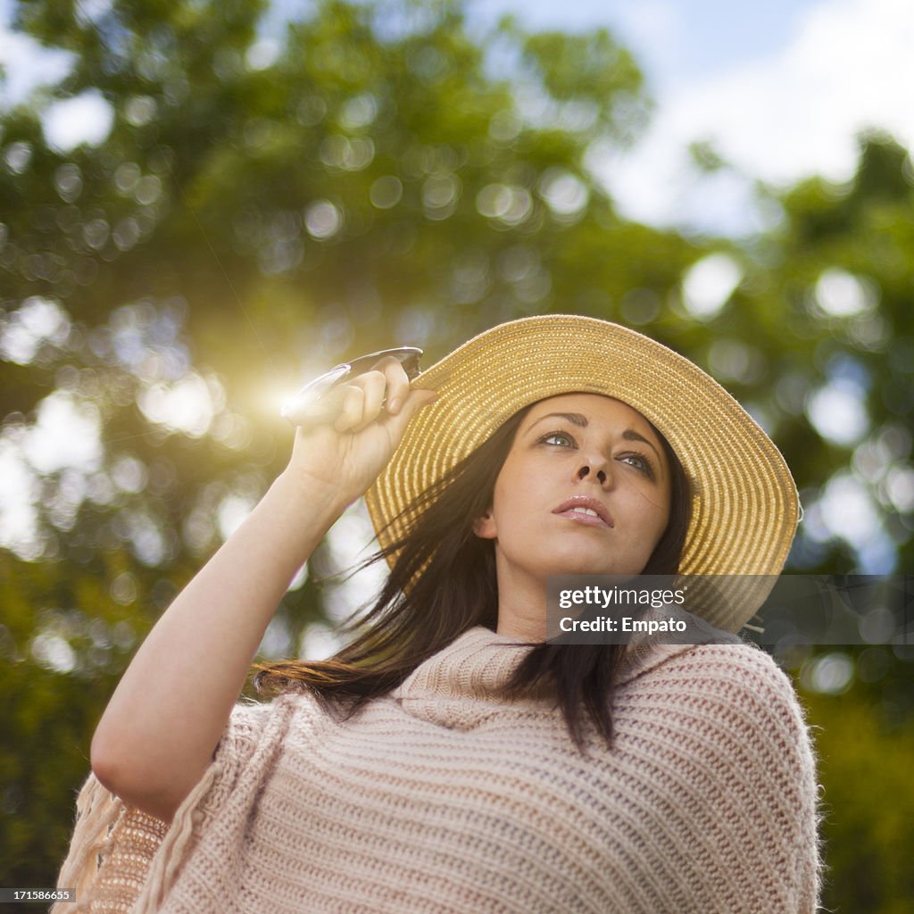 Girl in straw hat outdoors.