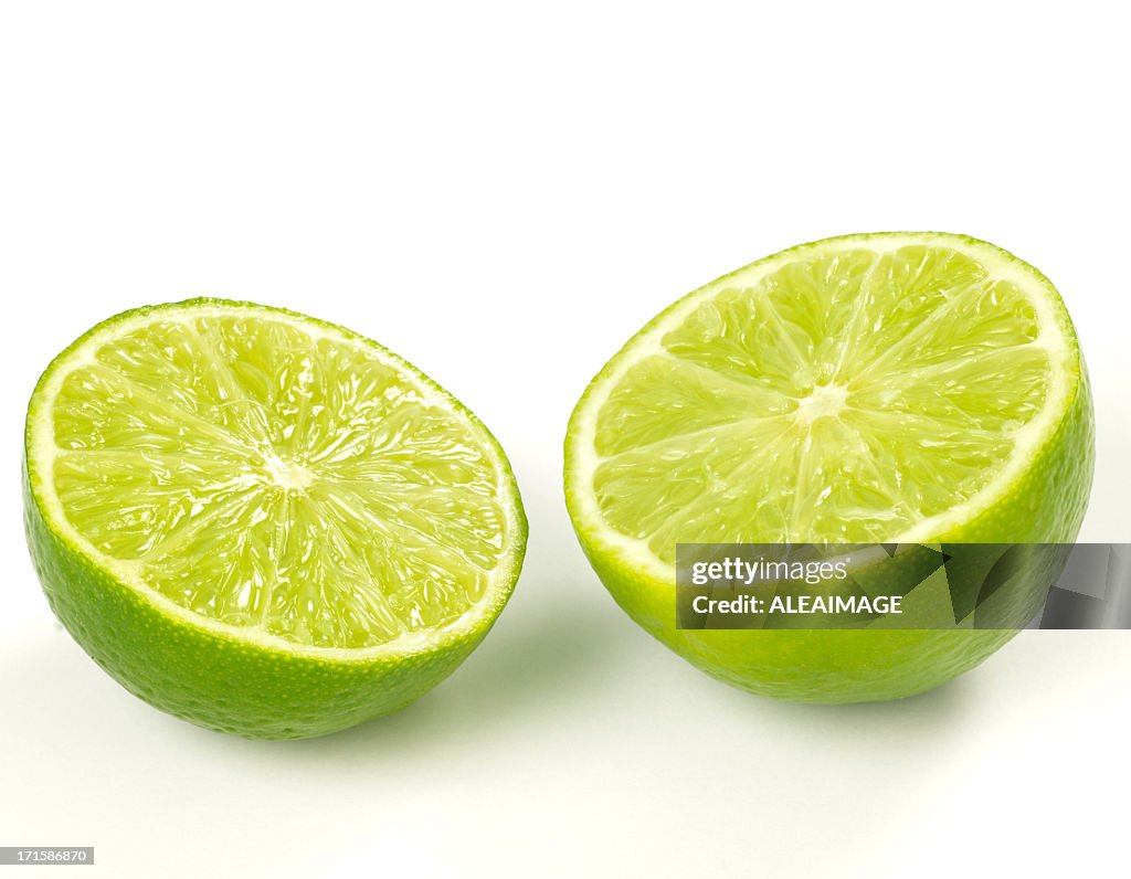 Close-up of two lime halves isolated on white