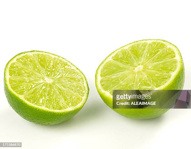 close-up of two lime halves isolated on white - lime bildbanksfoton och bilder