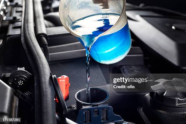 refilling the windshield washer system antifreeze - coolant stockfoto's en -beelden