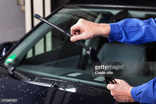 checking the windscreen wiper - windscreen stock pictures, royalty-free photos & images