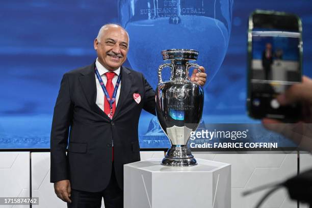 President of the Turkish Football Federation Mehmet Buyukeksi poses next to the trophy after Turkey was jointly elected to host the Euro 2032 fooball...