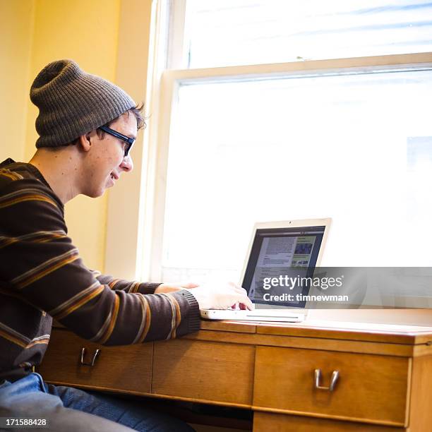 indoor studying college student on laptop - nerd sweater stock pictures, royalty-free photos & images