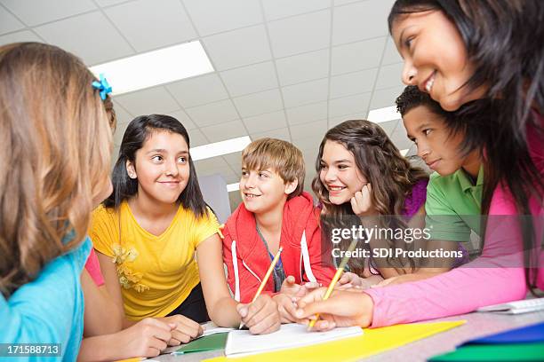 team of middle school students working on project together - 13 year old cute boys stock pictures, royalty-free photos & images
