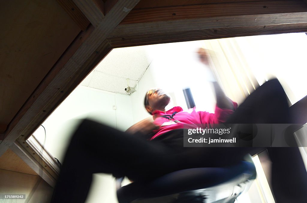 Businessman swinging in chair perusing document