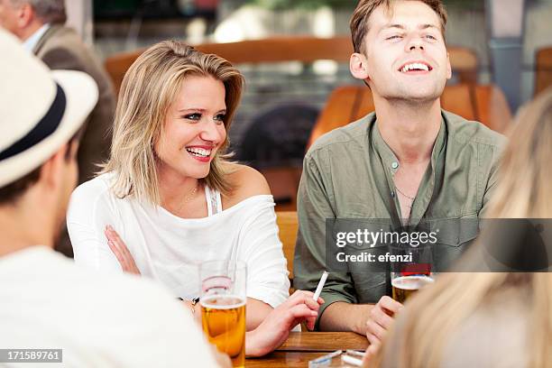 young adults drinking beer and smoking - cigarette smoking stockfoto's en -beelden