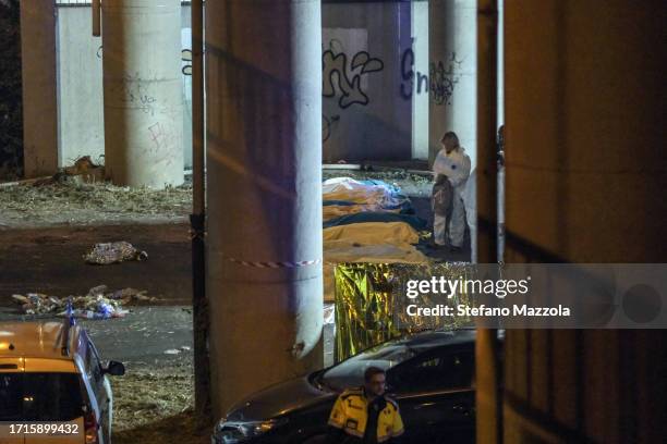 Victims who died after a bus carrying tourists crashed are moved under the overpass and covered with sheets on October 04, 2023 in Mestre, Italy. A...