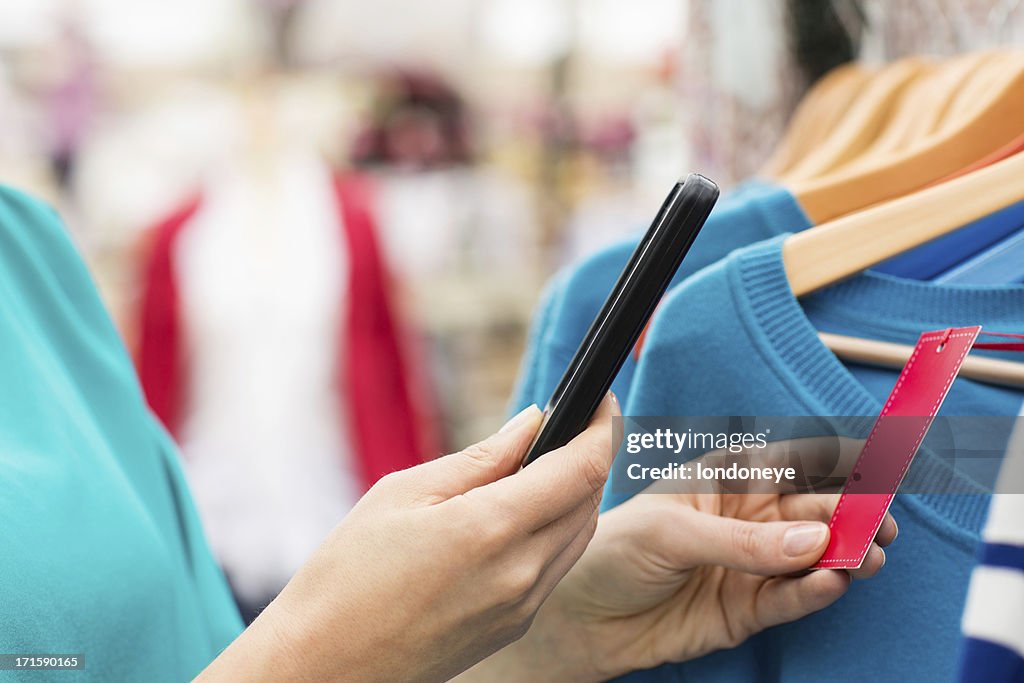 Woman Using Barcode Reader Through Smart Phone