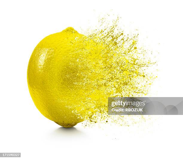 a splash coming off of a lemon on a white background - lemon juice bildbanksfoton och bilder