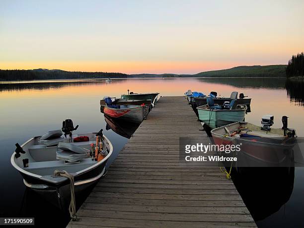 fishing boats line dock at sunset - kelowna stock pictures, royalty-free photos & images