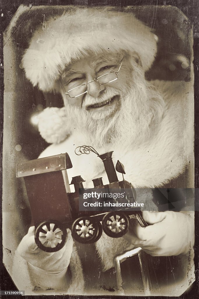 Pictures of Vintage Real Santa Claus holding a toy train