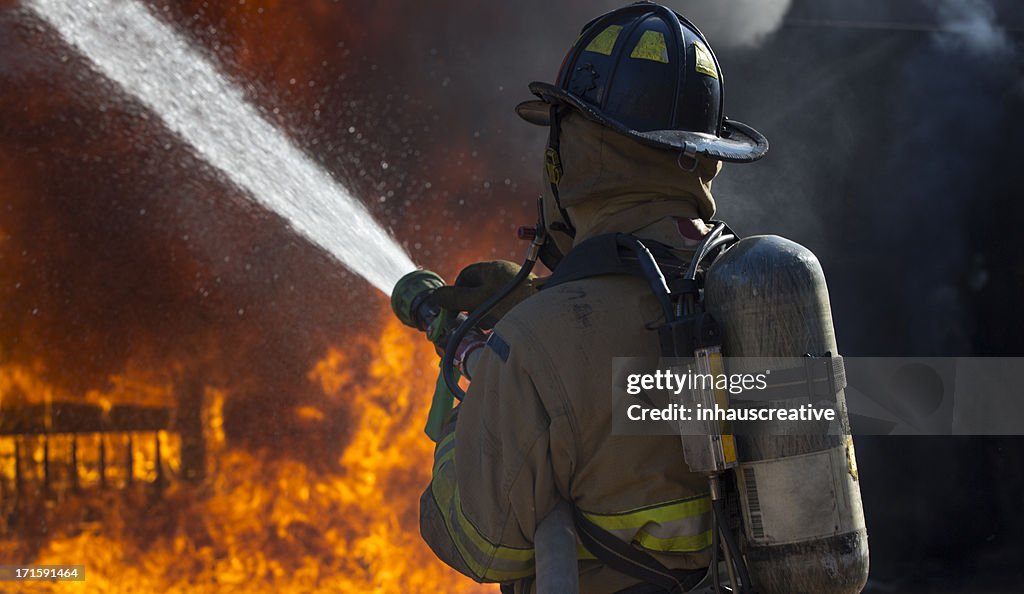 Fireman putting out a bedroom fire