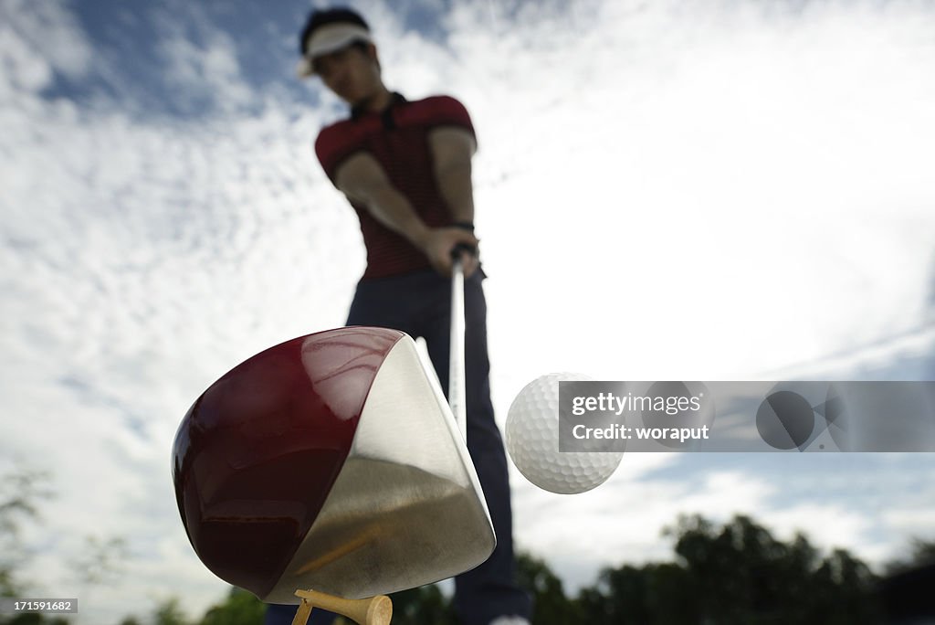 Upward view of a golfer mid golf swing