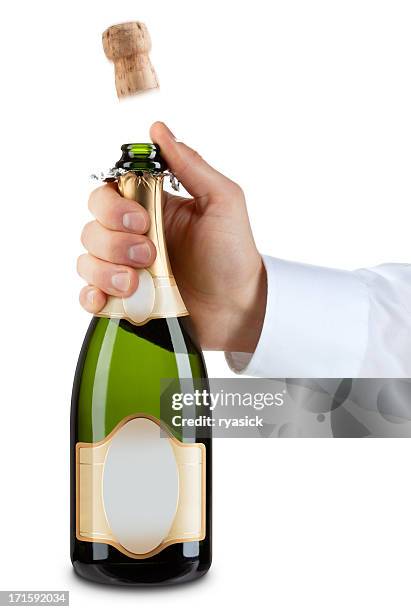 hand popping a cork from generic bottle of champagne - champagne popping stock pictures, royalty-free photos & images