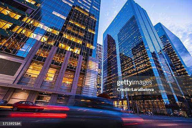 blurred car lights in motion on street in calgary at sunset - calgary stock pictures, royalty-free photos & images