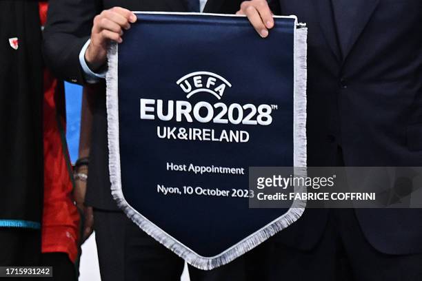 President Aleksander Ceferin and Welsh retired professional footballer, heading the delegation of UK and Ireland Gareth Bale , hold the pennant after...