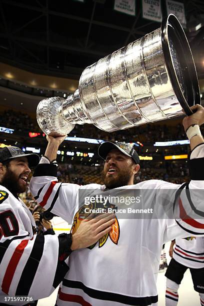 Viktor Stalberg of the Chicago Blackhawks hoist the Stanley Cup after defeating the Boston Bruins in Game Six of the 2013 NHL Stanley Cup Final at TD...