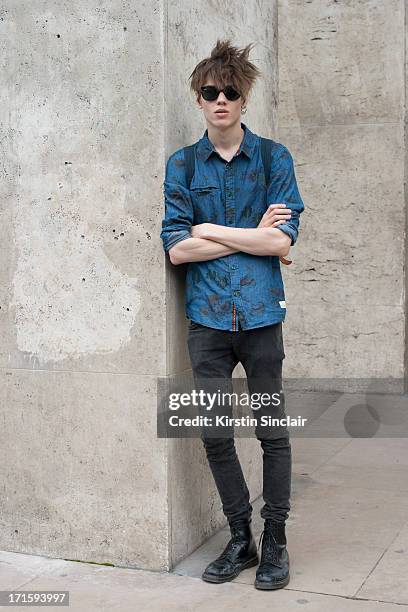 Model Sebastien Ahman wears an Anerrkjendt shirt, Ray Ban sunglasses, H and M jeans and Doc Martens boots on day 1 of Paris Collections: Men on June...