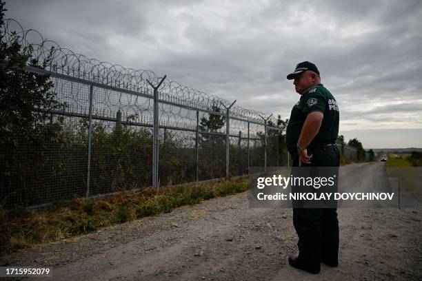 Bulgarian border police officer patrols near the wall fence on the Bulgaria-Turkey border near the village of Kapitan Andreevo, Bulgaria on October...