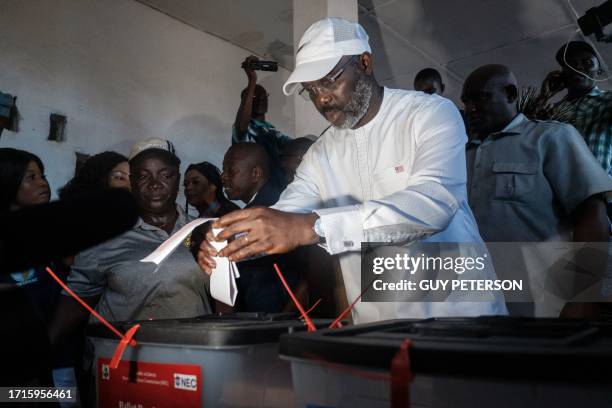 Liberia's Incumbent President George Weah casts his vote at a polling station in Monrovia on October 10, 2023 during the presidential vote. Liberians...