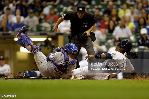 Rickie Weeks of the Milwaukee Brewers gets tagged out at home plate by Wellington Castillo of the Chicago Cubs during the bottom of the ninth inning...