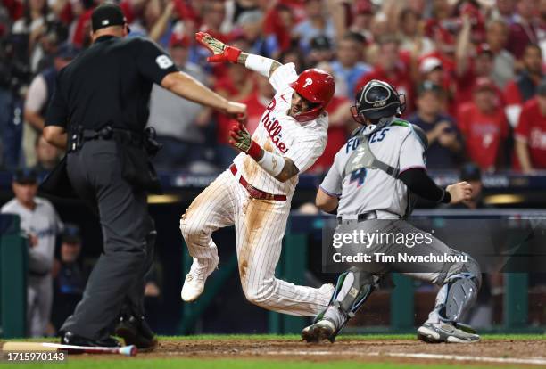 Nick Fortes of the Miami Marlins tags out Nick Castellanos of the Philadelphia Phillies at home plate during the fourth inning in Game One of the...