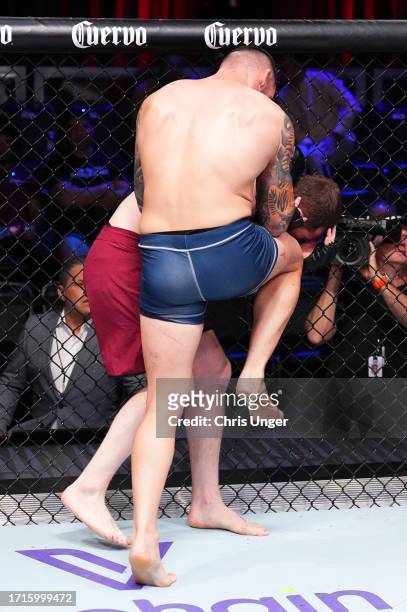 Rodolfo Bellato of Brazil knees Murtaza Talha of Russia in a light heavyweight fight during Dana White's Contender Series season seven, week nine at...
