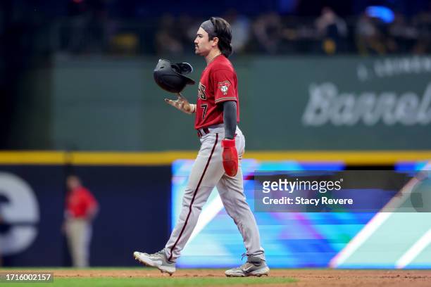 Corbin Carroll of the Arizona Diamondbacks walks across the field after being tagged out during a stolen base attempt in the seventh inning against...