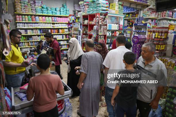 People buy supplies at a supermarket market in Gaza city, on October 10, 2023. Israel on October 10 has declared "a complete siege" on Gaza, cutting...