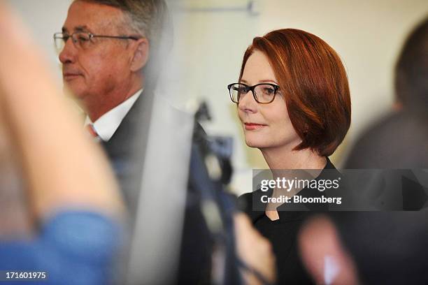 Julia Gillard, Australia's outgoing prime minister, right, and Wayne Swan, outgoing treasurer, leave the caucus room following a party leadership...