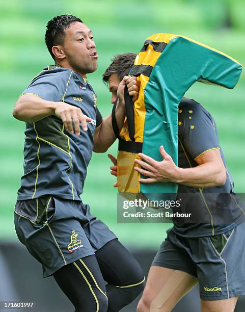 Christian Lealiifano of the Wallabies tackles during an Australian Wallabies training session at AAMI Park on June 27, 2013 in Melbourne, Australia.