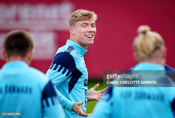 Denmark's forward Rasmus Hojlund warms up during a training session in Helsingoer, Denmark, on October 10 ahead of the UEFA Euro 2024 qualifying...