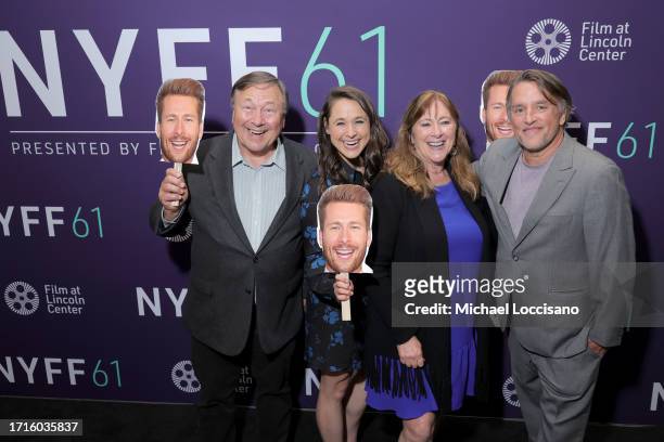 Director Richard Linklater poses with Glen Powell's family as they hold photo cutout boards of him in his absence due to the SAG-AFTRA strike at the...