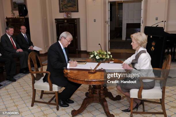 In this handout photo provided by the AUSPIC, Kevin Rudd is sworn in to the role of Prime Minister of Australia, by the Governor-General Quentin...