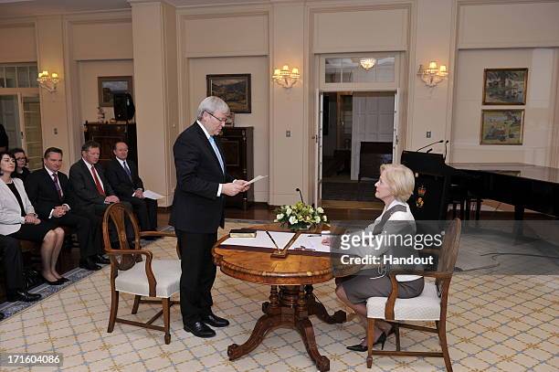 In this handout photo provided by the AUSPIC, Kevin Rudd is sworn in to the role of Prime Minister of Australia, by the Governor-General Quentin...