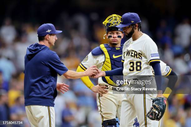Manager Craig Counsell of the Milwaukee Brewers relieves Devin Williams in the ninth inning against the Arizona Diamondbacks during Game One of the...