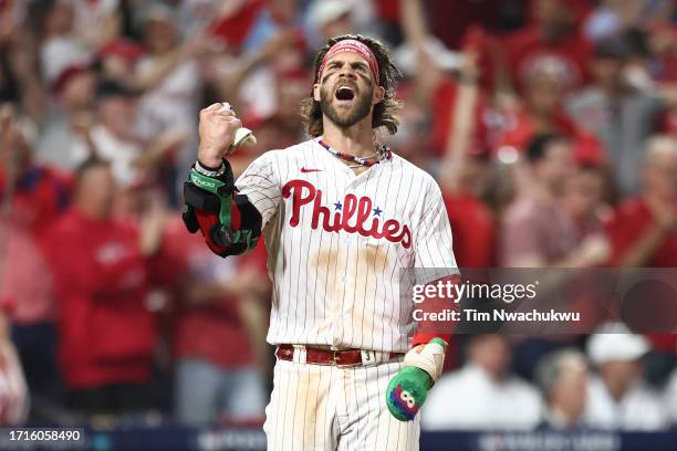 Bryce Harper of the Philadelphia Phillies celebrates after scoring a run during the eighth inning against the Miami Marlins in Game One of the Wild...