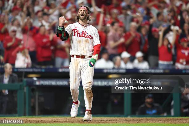 Bryce Harper of the Philadelphia Phillies celebrates after scoring a run during the eighth inning against the Miami Marlins in Game One of the Wild...